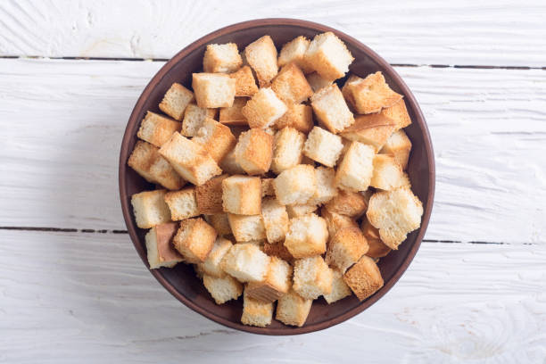 Crispy croutons in bowl stock photo