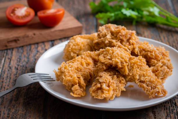 Crispy fried breaded chicken strips on plate Crispy fried breaded chicken strips on plate crunchy stock pictures, royalty-free photos & images