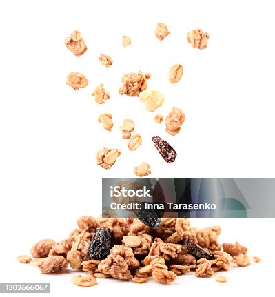 istock Crispy granola with raisins and banana falling on a heap on a white background. Isolated 1302666067