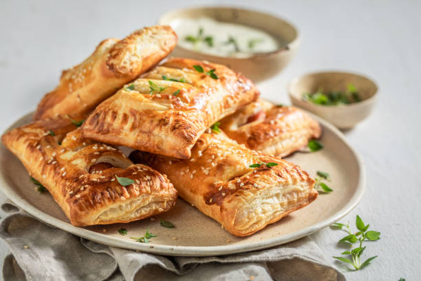 Crispy sausage roll with thyme and sesame seeds Crispy sausage roll with thyme and sesame seeds savory food stock pictures, royalty-free photos & images