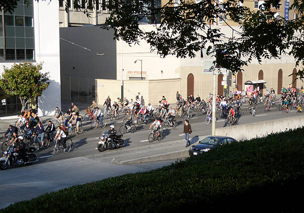 Critcal Mass bikers travel down 3rd street in mass stock photo