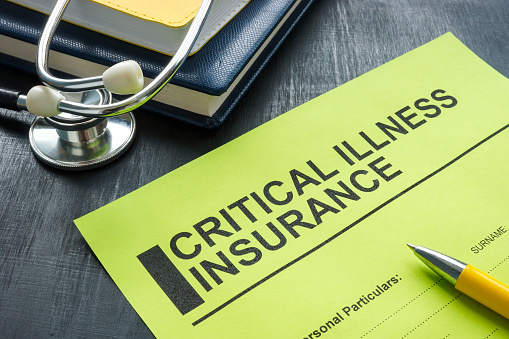 A Critical illness insurance form and notepad on the surface.