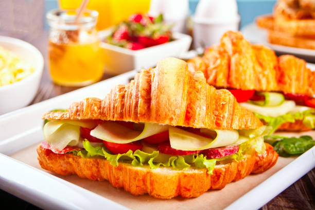 Croissant sandwiches with ham and cheese Breakfast concept. stock photo