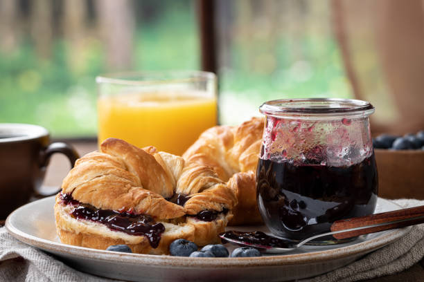 Croissants with blueberry jam stock photo