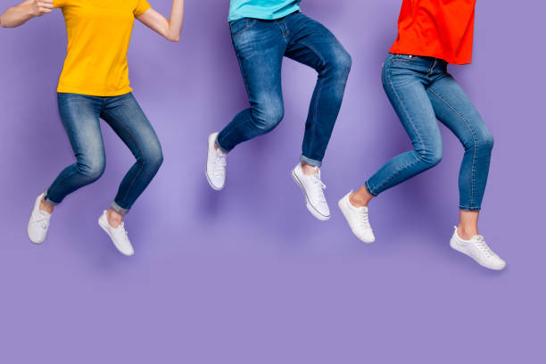 Cropped closeup photo of cheerful crazy ecstatic group of people running marathon hurrying to get seasonal discounts isolated violet background Cropped closeup photo of cheerful crazy ecstatic group of people running marathon, hurrying to get seasonal discounts isolated violet background jeans stock pictures, royalty-free photos & images