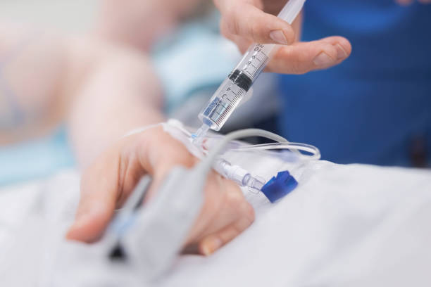 Cropped hand of doctor injecting patient stock photo