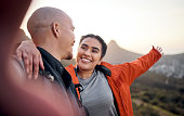 istock Cropped portrait of an affectionate young couple taking selfies while hiking in the mountains 1371447021