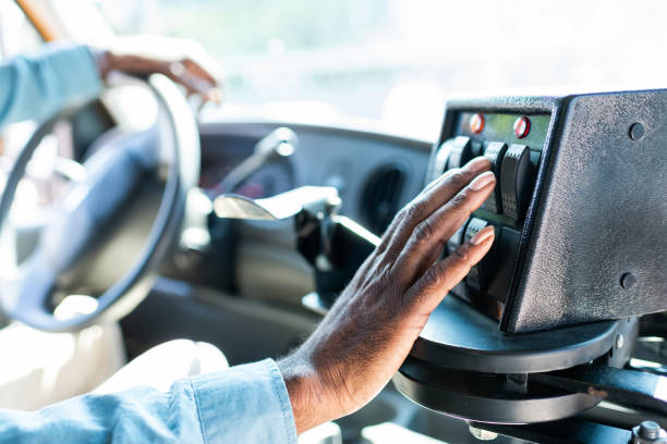 cropped shot of african american bus driver pushing buttons on panel at bus  school bus driver stock pictures, royalty-free photos & images
