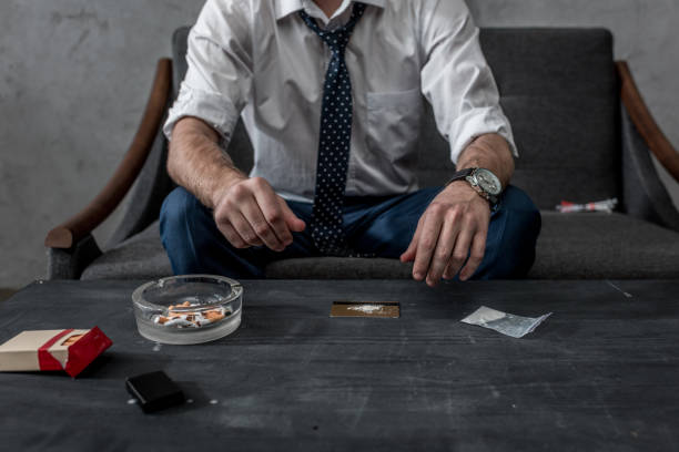 cropped shot of businessman with drug addiction preparing to take cocaine cropped shot of businessman with drug addiction preparing to take cocaine snorting stock pictures, royalty-free photos & images