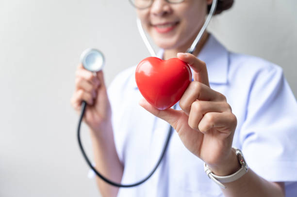 Cropped shot of healthcare worker holding a red heart toy with Stethoscope. stock photo