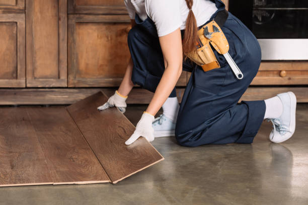 cropped shot of repairwoman installing laminate onto kitchen floor cropped shot of repairwoman installing laminate onto kitchen floor wood laminate flooring stock pictures, royalty-free photos & images