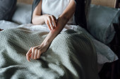 istock Cropped shot of young woman suffering from skin allergy, scratching her forearm with fingers 1354562475