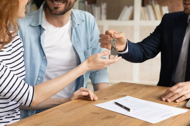 Cropped view happy couple receive keys from new own property stock photo