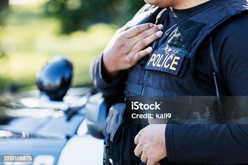 istock Cropped view of police officer 1310108875