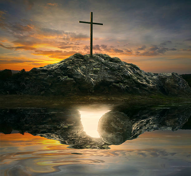 Cross and empty tomb A single cross with the reflection of an empty tomb. tomb stock pictures, royalty-free photos & images