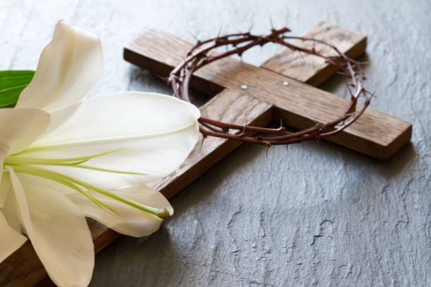 Cross and white lily on black marble background. Passion and resurrection of Christ concept  good friday stock pictures, royalty-free photos & images