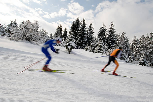 Cross country skiers practicing downhill stock photo