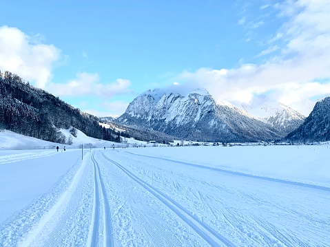 Cross country skiing trail in resort Studen, canton Schwyz in Switzerland.    The trail in deep snow is ready both for classic and skating styles. Mountains covered with snow are on the background.