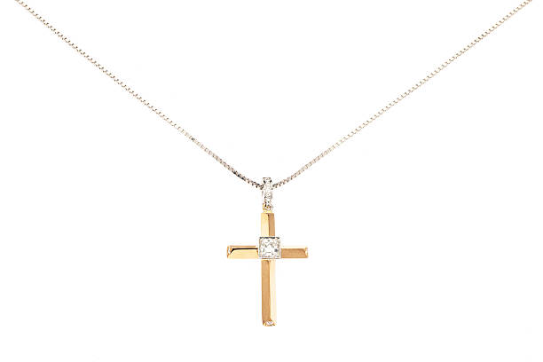 Cross Necklace Gold cross necklace on a gold chain with a white background cross necklace stock pictures, royalty-free photos & images