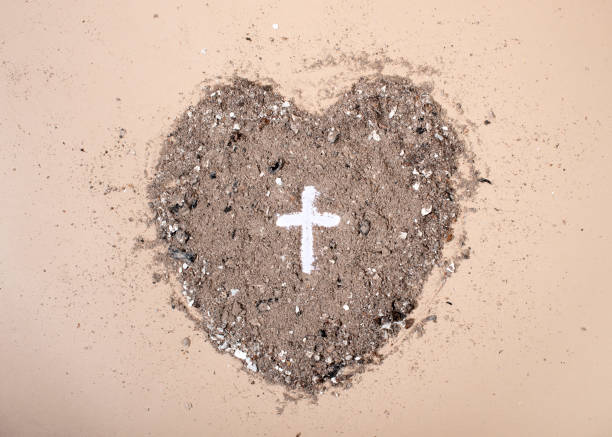 Cross or crucifix in heart shaped ash. Lent Season, Holy Week and Good Friday concept.  good friday stock pictures, royalty-free photos & images