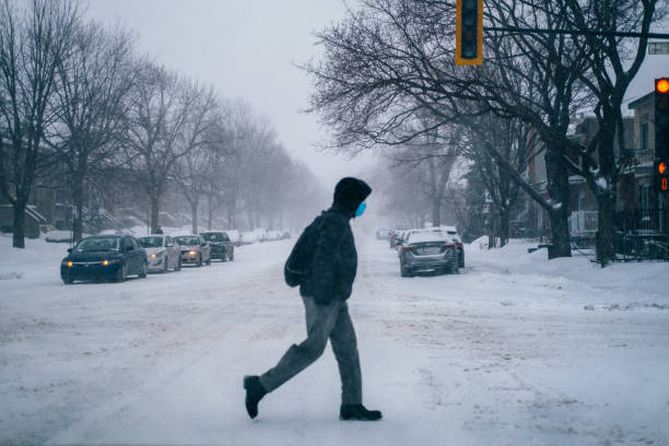 Crossing the road during the snowstorm in Montréal stock photo