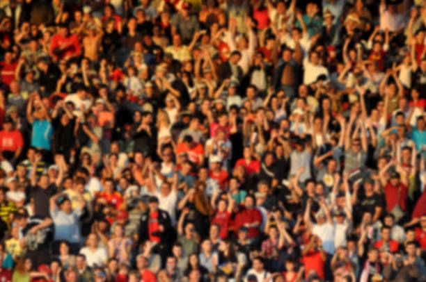 Crowd in a stadium. Blurred heads and faces of spectators stock photo