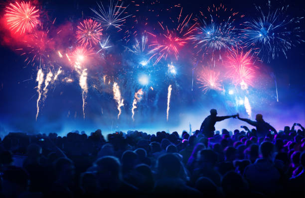 Crowd in front of vibrant firework display stock photo