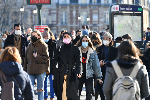 Paris, France-03 06 2021:People wearing protective face masks in a crowded street of Paris, France during the global coronavirus epidemic.
