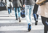 Crowd of people walking on zebra crossing street city center - Concept of modern, rushing, urban, city life, business, shopping - Soft focus on top guy left black shoe