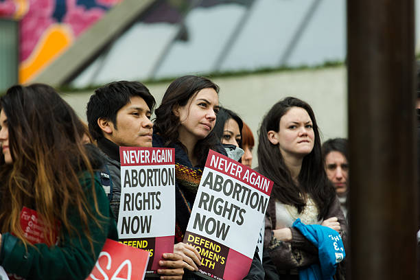 Crowd of pro-abortion protesters in the streets of Dublin Dublin, Ireland - March 8, 2014: A crowd participating in pro abortion protest organised by ROSA on International Women's Day. abortion protest stock pictures, royalty-free photos & images