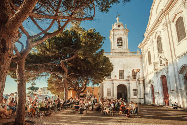 crowd of visitors of outdoor restaurant drinking and relaxing on terrace with beautiful city view - people portugal imagens e fotografias de stock
