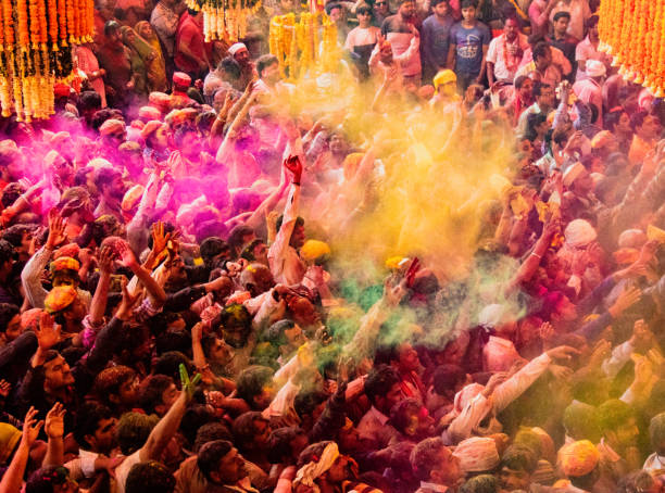 Crowds can be seen below duirng Holi Festival in India, throwing powdered paint Barsana, India, Holi Festival, Feb 24, 2018 - Crowds can be seen below duirng Holi Festival in India, throwing powdered paint holi photos stock pictures, royalty-free photos & images