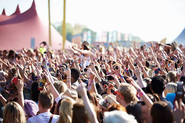 Crowds Enjoying Themselves At Outdoor Music Festival Crowds Enjoying Themselves At Outdoor Music Festival Hands In The Air entertainment event stock pictures, royalty-free photos & images