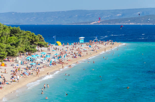 Crowds of people on Golden Cape beach. Golden Cape is the most famous beach in Croatia located on Brac island. stock photo