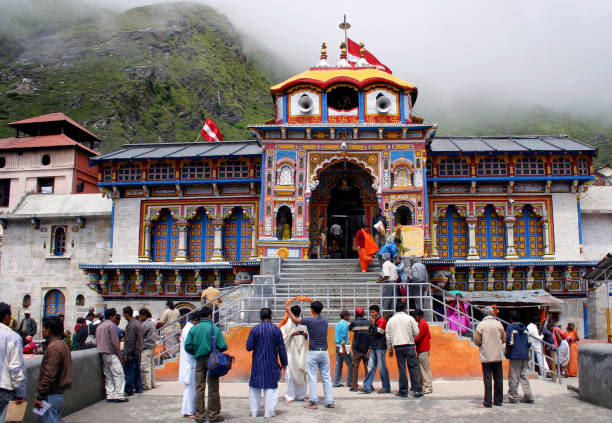 Crowds throng the Hindu Temple at Badrinath, Uttarkhand,India Temple for Lord Vishnu, the God who protects and preserves the Universe. He is also known by the name of  Badrinarayan. This holy shrine of Badrinath is an important pilgrimage center for Hindus. Temple is located on the banks of the Alakananda river, a tributary of the Ganges, in the mountainous district of Garhwal Himalayas, Uttarkhand. On account of its high altitude, extreme weather and difficult approach, it is open for only six months a year during summer. The location is very old and finds mention in the Vedas and other ancient Hindu sacred  texts, dating it to nearly 1700 BC. BADRINATH stock pictures, royalty-free photos & images
