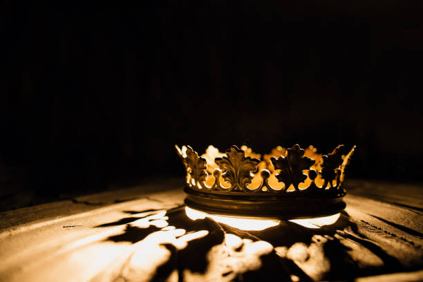 Crown of the real king on a black background. Game of Thrones. The crown on a black background is highlighted by a golden ray. Game of Thrones. crown headwear stock pictures, royalty-free photos & images