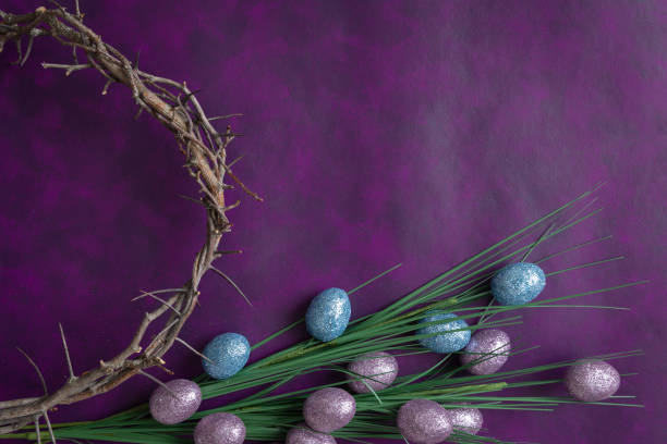 Crown of thorns and Easter eggs on purple Partial crown of thorns and pink and blue decorative sparkly Easter eggs on a dark purple background with copy space easter sunday stock pictures, royalty-free photos & images