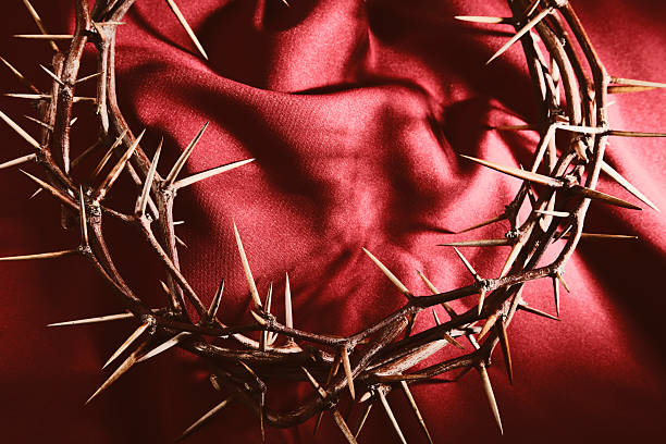 Crown of Thorns on Red Cloth Background  good friday stock pictures, royalty-free photos & images
