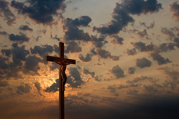 Crucifix and Dramatic Sky  good friday stock pictures, royalty-free photos & images