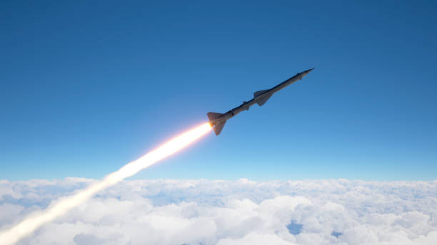 Cruise missile fly above the clouds stock photo