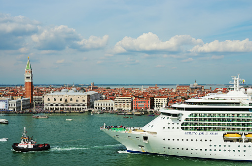 Venice, Italy- Sept 24, 2014: The cruise ship Serenade of the Seas crosses the Venetian Lagoon at morning. More than 10 million tourists visit Venice every year