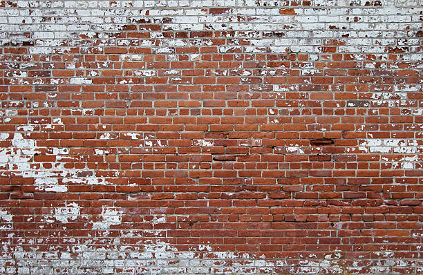 Crumbing Red Brick Wall with Anchor Bolt Sleeves stock photo