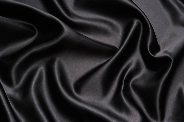 crumpled black satin texture background - black fabric stockfoto's en -beelden