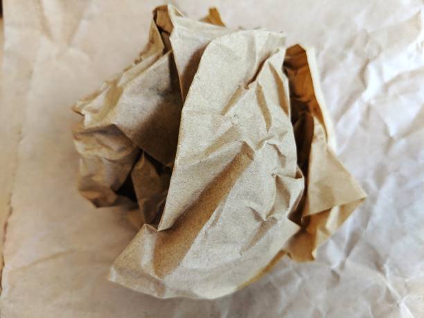 Crumpled brown wax paper wrapper in a ball stock photo
