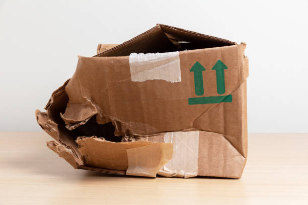 crumpled cardboard mail box Empty torn and wrinkled cardboard box. Concept of shopping, delivery and cargo insurance. crushed stock pictures, royalty-free photos & images