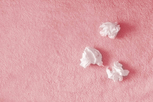 Crumpled handkerchiefs, paper napkins on a pink background with a fluffy carpet. The concept of illness, snot, insomnia and tears. Place for text, copy space. Crumpled handkerchiefs, paper napkins on a pink background with a fluffy carpet. The concept of illness, snot, insomnia and tears. Place for text, copy space handkerchief stock pictures, royalty-free photos & images