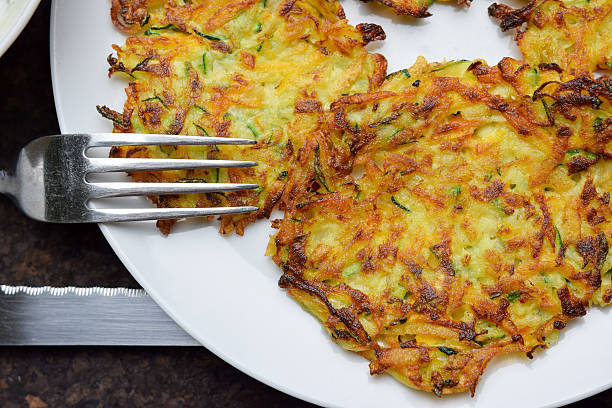 Crunchy potato and zucchini pancakes Hommane, pan fried crunchy potato pancakes with zucchini and carrot. Perfect for breakfast and for lunch. hash brown stock pictures, royalty-free photos & images