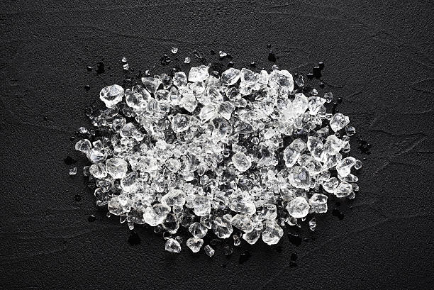 Crushed ice on black stone table top view stock photo