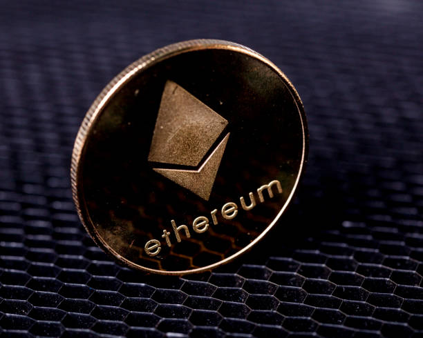 Cryptocurrency ethereum coin on euro bills Rezekne, Latvia - February 19, 2021: Cryptocurrency ethereum coin displayed on a euro bills With Ethereum stock pictures, royalty-free photos & images