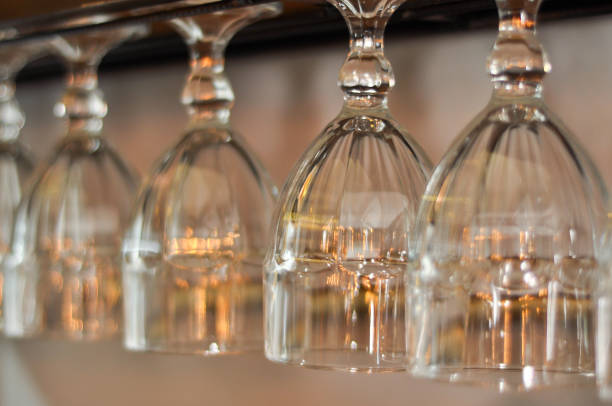 Crystal glasses hanging on a bar couter restaurant stock photo